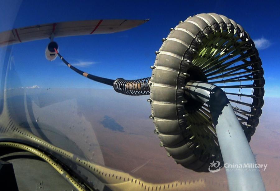 A fighter jet approaches a tanker aircraft for refuel during the \