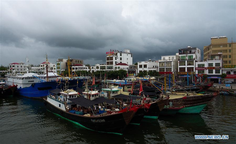 Fishing boats berth at a harbor in Qionghai, south China\'s Hainan Province, July 17, 2018. Ferry services on the Qiongzhou Strait in south China have been halted as of Tuesday afternoon as a typhoon is fast approaching the southern provinces of Hainan and Guangdong, local authorities have said. Son-Tinh, the ninth typhoon this year, is expected to make landfall in Hainan and Guangdong on Wednesday morning, according to China\'s National Meteorological Center. (Xinhua/Yang Guanyu)