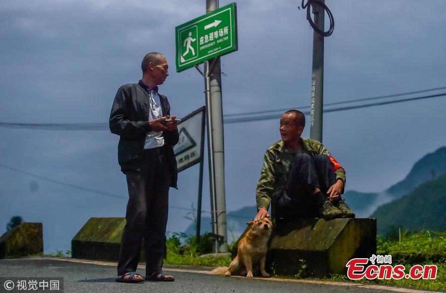 Mou Huaiqing, 65, and his colleague patrol a valley at night in Dujiangyan City, Southwest China’s Sichuan Province. For the past nine years, since the deadly May 12 earthquake in 2008, Mou and his colleagues have been responsible for 24-hour monitoring of the valley from May to October for signs of potential landslides that could pose a threat to local villagers. They check for any cracks on mountain slopes, for example. Mou helped evacuate 300 residents and tourists in a timely manner as he sounded an alarm to warn of a landslide in August 2010. The team has sounded warnings for a dozen geological hazards. (Photo/VCG)