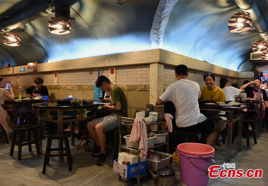 A popular hot pot restaurant inside a former air-raid shelter in Southwest China’s Chongqing Municipality, July 17, 2018. Authorities in Chongqing have allowed for the development of air-raid shelters, and they have been converted into wine cellars, restaurants and gas stations. The venues become especially popular in summer as it’s usually cool inside. (Photo: China News Service/Zhou Yi)
