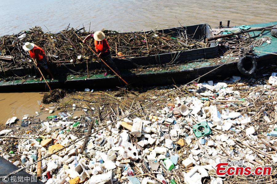 Garbage piles up on the banks of the Yangtze River after floodwaters subside in Yunyang County, Southwest China’s Chongqing Municipality, July 17, 2018. Over 1,500 tons of garbage were cleaned up a day. The Three Gorges Reservoir received a massive 60, 000 cubic meters of water a second after heavy rain in the upper reaches of the Yangtze River. Local authorities have warned more heavy rain and floods are expected to hit the Three Gorges Reservoir this year. (Photo/VCG)