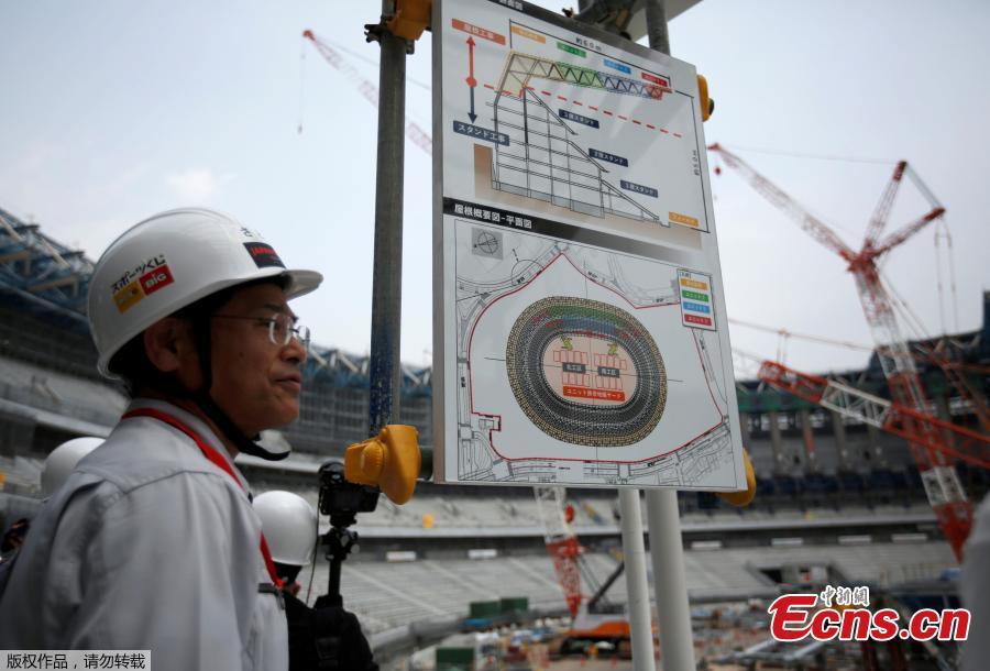 Workers and media members are seen at the construction site of the New National Stadium, the main stadium of Tokyo 2020 Olympics and Paralympics, during a media opportunity in Tokyo, Japan, July 18, 2018. As the two-year mark approaches for the Tokyo 2020 Olympics, Japan is being scorched by an intense heatwave that has prompted fears of similar extreme weather when the sporting showpiece takes place in the country. (Photo/Agencies)