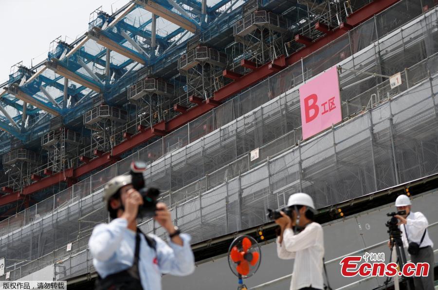 Media members are seen at the construction site of the New National Stadium, the main stadium of Tokyo 2020 Olympics and Paralympics, during a media opportunity in Tokyo, Japan, July 18, 2018. As the two-year mark approaches for the Tokyo 2020 Olympics, Japan is being scorched by an intense heatwave that has prompted fears of similar extreme weather when the sporting showpiece takes place in the country. (Photo/Agencies)