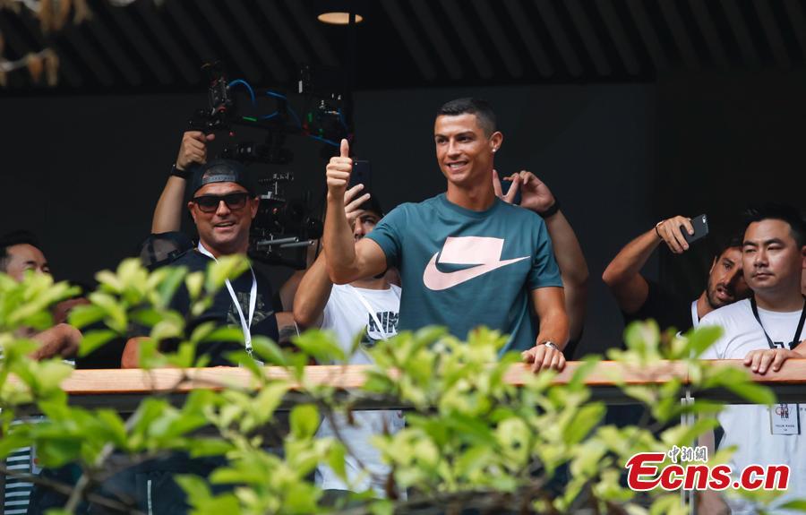Portuguese professional footballer Cristiano Ronaldo waves to fans during a commercial activity in Beijing, July 19, 2018. (Photo: China News Service/Jia Tianyong)