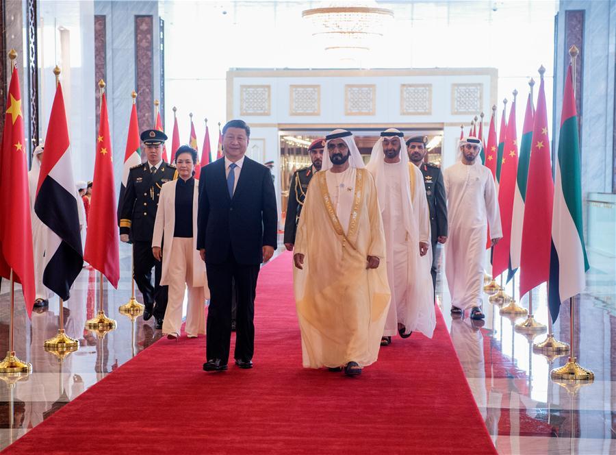 Chinese President Xi Jinping and his wife Peng Liyuan, accompanied by the United Arab Emirates (UAE) Vice President and Prime Minister Sheikh Mohammed bin Rashid Al Maktoum and the Crown Prince of Abu Dhabi Sheikh Mohammed bin Zayed Al Nahyan, head for a reviewing hall in Abu Dhabi, the UAE, July 19, 2018. Xi arrived here on Thursday for a state visit to the UAE. The UAE\'s vice president hosted a welcome ceremony for the Chinese president at the airport. (Xinhua/Li Xueren)
