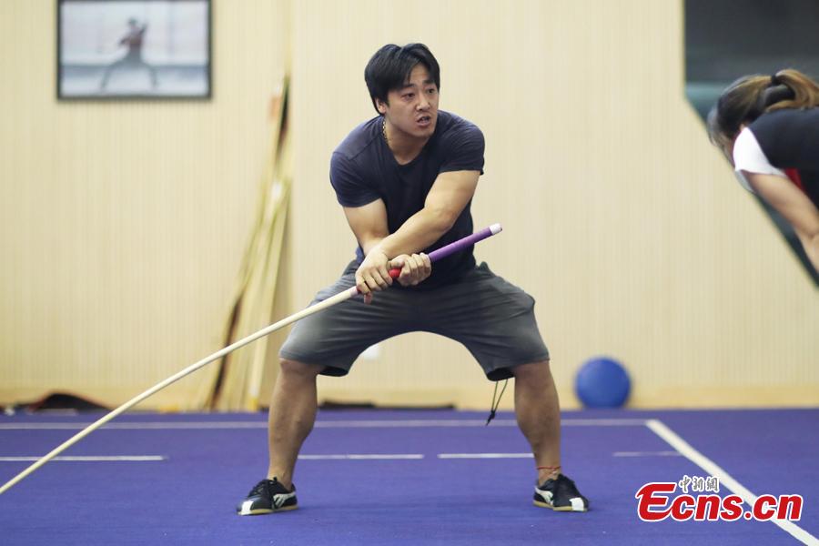 A member of the Nanjing Agricultural University Martial Arts Team trains for the upcoming China University Students Martial Arts Routine Championship in Nanjing City, East China’s Jiangsu Province, July 19, 2018, as temperatures hit approximately 35 degrees centigrade. (Photo: China News Service/Yang Bo)