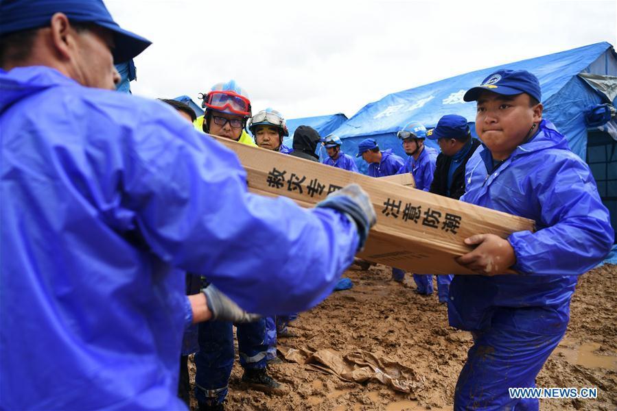 Rescuers convey disaster relief materials at flood-hit Chenhe Village of Dongxiang Autonomous County in Linxia Hui Autonomous Prefecture, northwest China\'s Gansu Province, July 20, 2018. About 1.08 million people in Gansu Province were affected by rain-triggered floods, with 12 deaths, four people missing and 27,000 people evacuated. (Xinhua/Chen Bin)