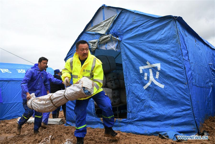 Rescuers convey disaster relief materials at flood-hit Chenhe Village of Dongxiang Autonomous County in Linxia Hui Autonomous Prefecture, northwest China\'s Gansu Province, July 20, 2018. About 1.08 million people in Gansu Province were affected by rain-triggered floods, with 12 deaths, four people missing and 27,000 people evacuated. (Xinhua/Chen Bin)