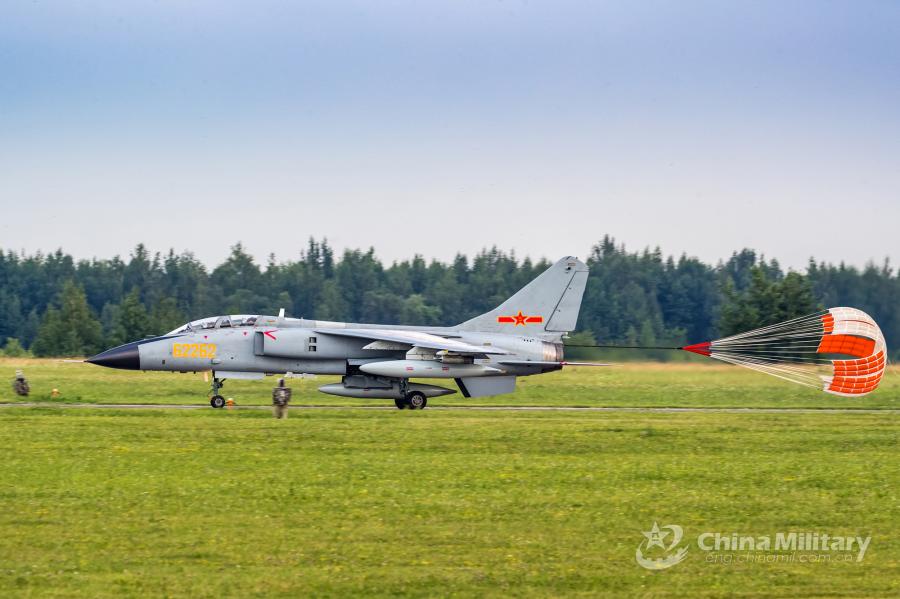 A JH-7A fighter bomber attached to the PLA Air Force deploys its drogue parachute to slow itself after landing at the airport on July 20. All aircraft of the PLA Air Force to participate in the \