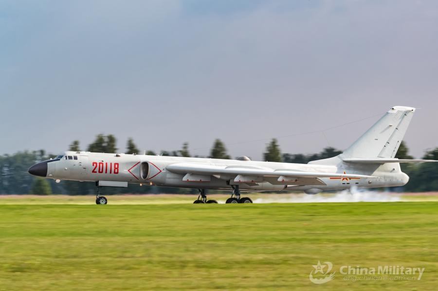 An H-6K bomber attached to the Chinese PLA Air Force taxies on the runway after landing at the airport on July 20. All aircraft of the PLA Air Force to participate in the \