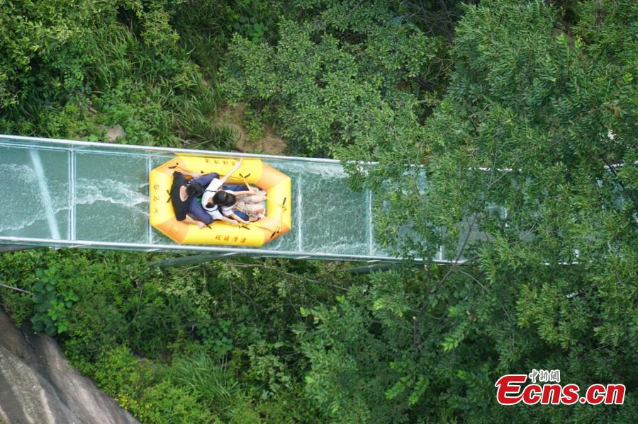 An aerial view of a waterslide over the Xiangma River in Lushan County, Central China’s Henan Province, July 23, 2018. The 2.3-kilometer-long waterslide around a mountain slope and cliff has a vertical drop of 100 meters, earning it the title of the longest and most challenging waterslide in central China. The thrilling project opened on Monday. (Photo: China News Service/Dong Fei)
