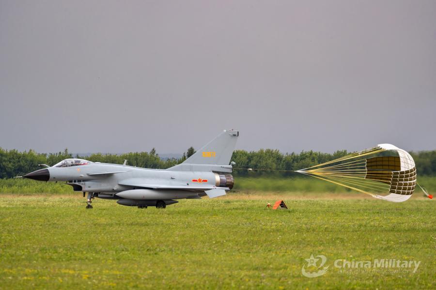 A J-10A fighter jet attached to the Chinese PLA Air Force deploys its drogue parachute to slow itself after landing at the airport on July 21. All aircraft of the PLA Air Force to participate in the \