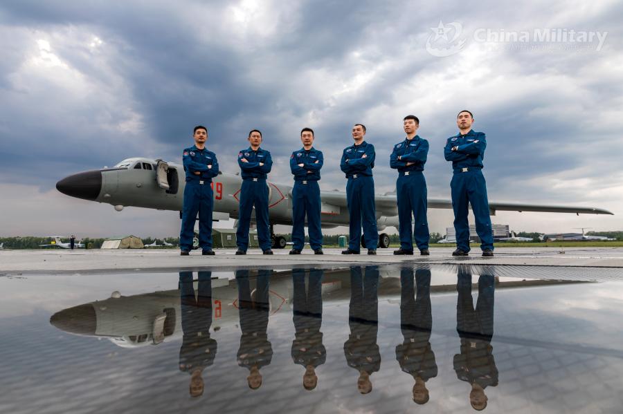 Pilots assigned to the Chinese PLA Air Force stand in front of an H-6K bomber on July 20. All aircraft of the PLA Air Force to participate in the \