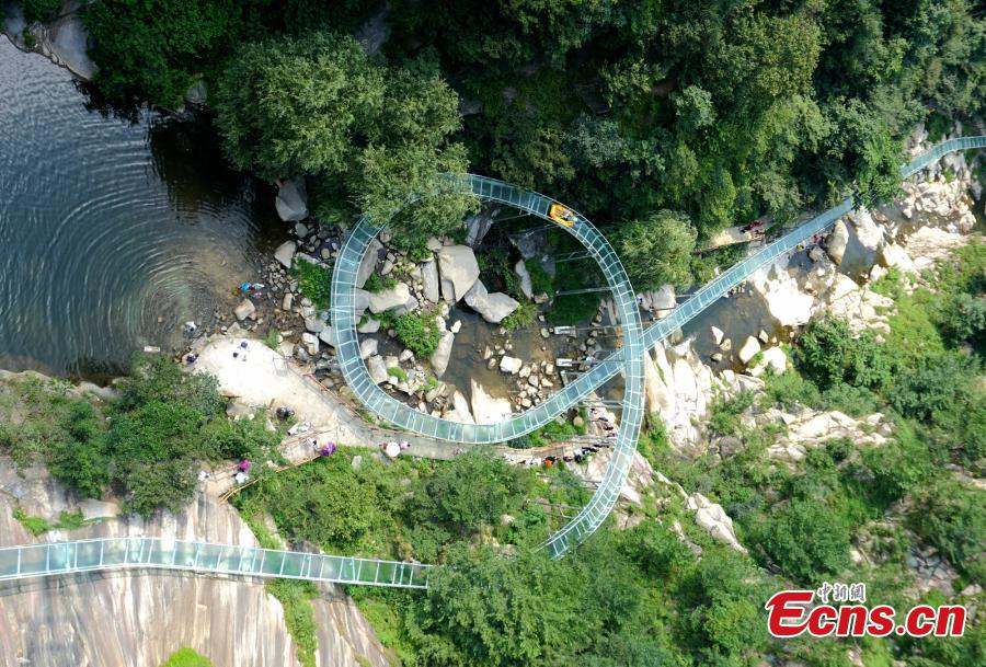 An aerial view of a waterslide over the Xiangma River in Lushan County, Central China’s Henan Province, July 23, 2018. The 2.3-kilometer-long waterslide around a mountain slope and cliff has a vertical drop of 100 meters, earning it the title of the longest and most challenging waterslide in central China. The thrilling project opened on Monday. (Photo: China News Service/Dong Fei)