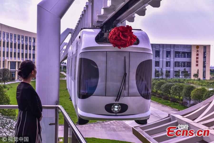 A suspension railway with carriages resembling pandas takes a trial run in Dayi County, Chengdu City, Southwest China’s Sichuan Province, July 21, 2018. Chengdu has announced it will start construction on an elevated monorail linking Dayi Station on the Chengdu?Pujiang Intercity Railway and Anren Town in Dayi County. The 11.2-kilometer-long tourist railway will have a total investment of 2.178 billion yuan ($321 million), with construction expected to be complete in 17 months. Chengdu will experiment with the ‘sky train’ project while promoting its transportation network. (Photo/VCG)