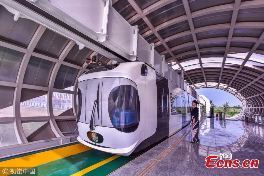 A suspension railway with carriages resembling pandas takes a trial run in Dayi County, Chengdu City, Southwest China’s Sichuan Province, July 21, 2018. Chengdu has announced it will start construction on an elevated monorail linking Dayi Station on the Chengdu?Pujiang Intercity Railway and Anren Town in Dayi County. The 11.2-kilometer-long tourist railway will have a total investment of 2.178 billion yuan ($321 million), with construction expected to be complete in 17 months. Chengdu will experiment with the ‘sky train’ project while promoting its transportation network. (Photo/VCG)