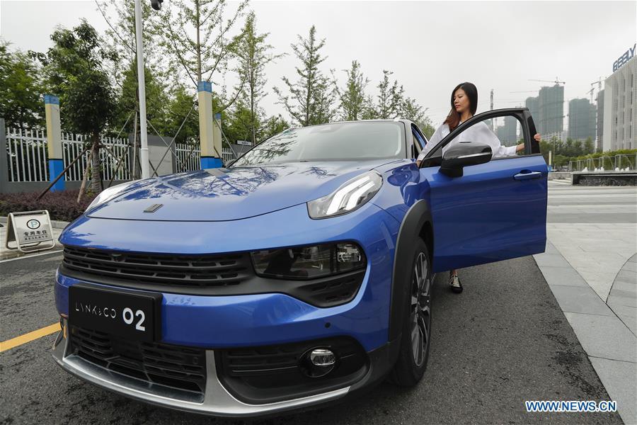 A visitor takes a test drive of Lynk & Co 02 at a research and development center of Geely Auto in east China\'s Zhejiang Province, July 3, 2018. This year marks the 40th anniversary of China\'s reform and opening-up policy. (Xinhua/Shen Bohan)
