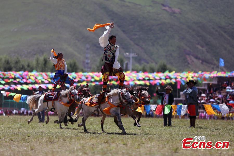 An annual horse racing festival starts in Yushu, Northwest China’s Qinghai Province, July 25, 2018 with stunts performed in the opening ceremony. (Photo: China News Service/Luo Yunpeng)