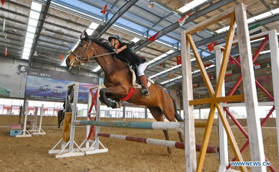 Zhou Jian, a student of Sunshine Riding School, trims a horse\'s hooves in Yihuang County of Fuzhou, east China\'s Jiangxi Province, May 8, 2018. Equestrianism had never been heard of in Yihuang, an agricultural county in east China\'s Jiangxi Province, until Sunshine Riding School began recruiting rural teenagers in 2015. So far, most of the 90 students are working or aspiring to work in horse riding clubs in China\'s largest cities such as Beijing, Shanghai and Hangzhou. (Xinhua/Zhou Mi)