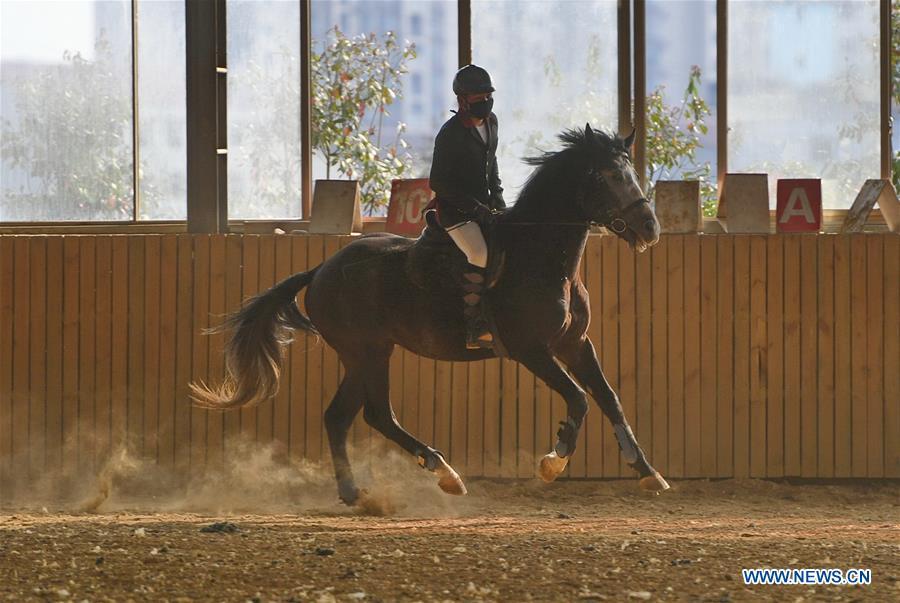 A student attends a training session at Sunshine Riding School in Yihuang County of Fuzhou, east China\'s Jiangxi Province, March 13, 2018. Equestrianism had never been heard of in Yihuang, an agricultural county in east China\'s Jiangxi Province, until Sunshine Riding School began recruiting rural teenagers in 2015. So far, most of the 90 students are working or aspiring to work in horse riding clubs in China\'s largest cities such as Beijing, Shanghai and Hangzhou. (Xinhua/Zhou Mi)