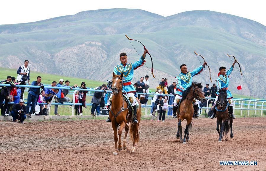 Horsemen perform equestrianism during a traditional ethnic minorities sports meeting held at a racecourse in Sunan Yugur Autonomous County, northwest China\'s Gansu Province, July 28, 2018. (Xinhua/Wang Jiang)