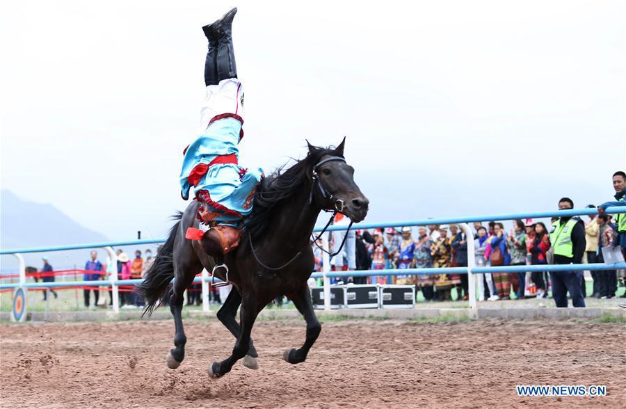 A horseman performs equestrianism during a traditional ethnic minorities sports meeting held at a racecourse in Sunan Yugur Autonomous County, northwest China\'s Gansu Province, July 28, 2018. (Xinhua/Wang Jiang)