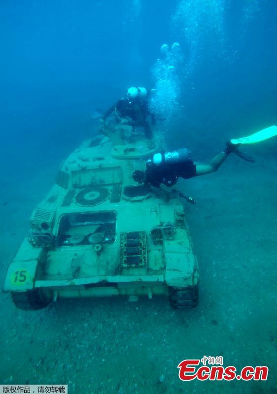 Divers swim around immersed tanks off the coast of Sidon, Lebanon, July 28, 2018. Lebanese environmentalists sank 10 old tanks and other armored vehicles to the bottom of the Mediterranean Sea in a novel attempt to attract divers and create new habitats for marine life. (Photo/Agencies)