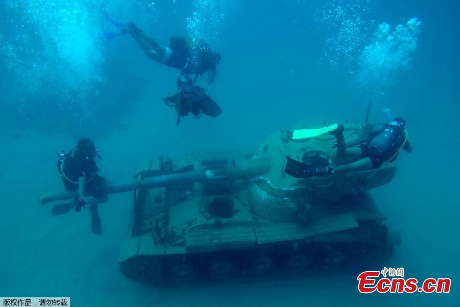 Divers swim around immersed tanks off the coast of Sidon, Lebanon, July 28, 2018. Lebanese environmentalists sank 10 old tanks and other armored vehicles to the bottom of the Mediterranean Sea in a novel attempt to attract divers and create new habitats for marine life. (Photo/Agencies)