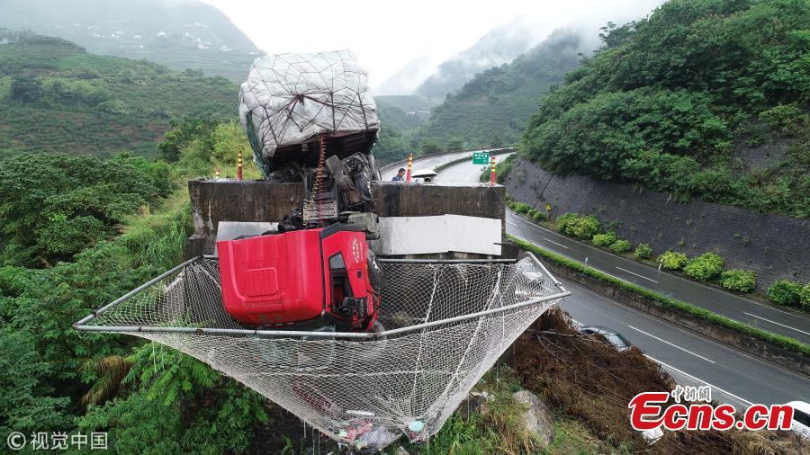 A cargo truck’s cabin hangs on a slip road in Yuxi City, Southwest China’s Yunnan Province, July 26, 2018. Having lost control of the truck on a 27-kilometer-long downward slope, known as the \