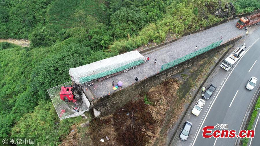 A cargo truck’s cabin hangs on a slip road in Yuxi City, Southwest China’s Yunnan Province, July 26, 2018. Having lost control of the truck on a 27-kilometer-long downward slope, known as the \