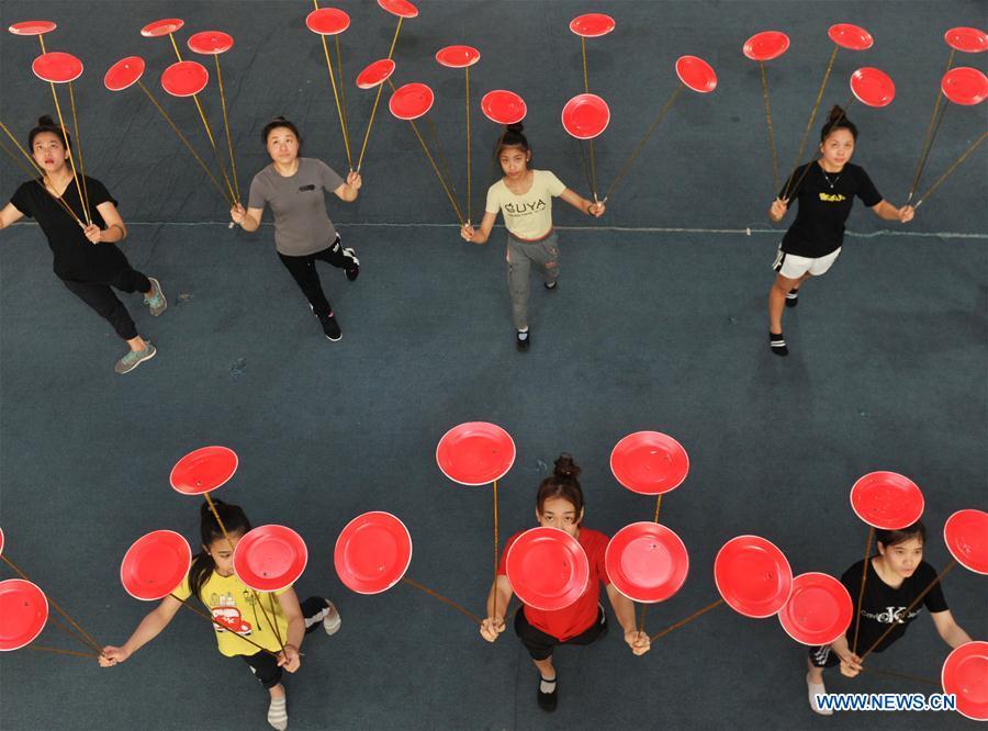 Students from Laos practise in Wuqiao Acrobatic Art School in Cangzhou, north China\'s Hebei Province, July 30, 2018. Wuqiao county is known as \