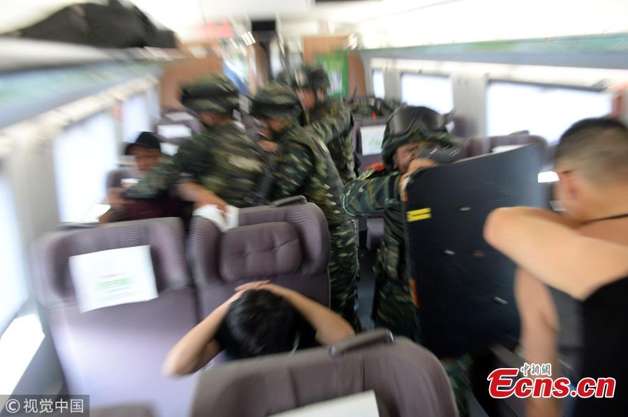 Armed police officers take part in a drill that simulated a hostage-taking crisis on a high-speed train in Hefei City, East China’s Anhui Province, July 30, 2018. The drill aimed to enhance preparedness against transportation emergencies. (Photo/VCG)