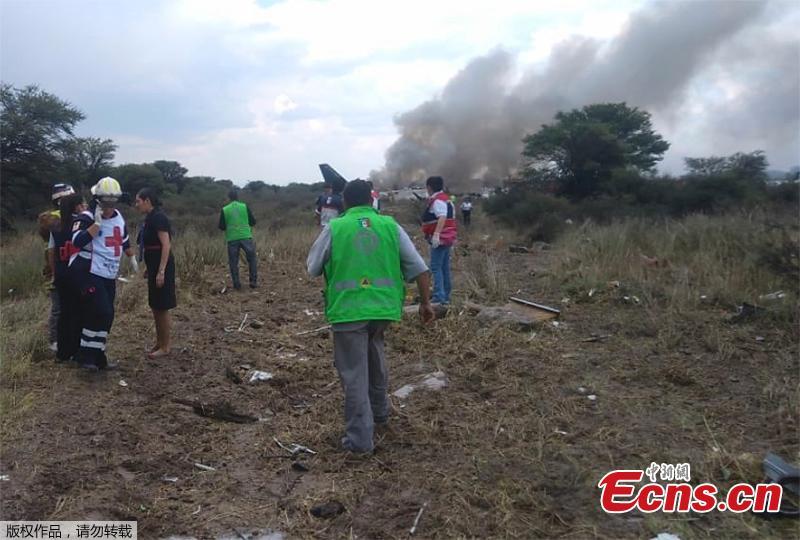 Rescue workers and firefighters are seen at the site where an Aeromexico airliner has suffered an “accident” in a field near the airport of Durango, Mexico, Tuesday, July 31, 2018. (Photo/Agencies)