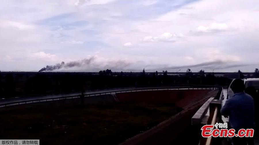 A person watches as smoke billows above a site where an Aeromexico-operated Embraer passenger jet crashed in Mexico\'s northern state of Durango, July 31, 2018, in this still image taken from a video. (Photo/Agencies)