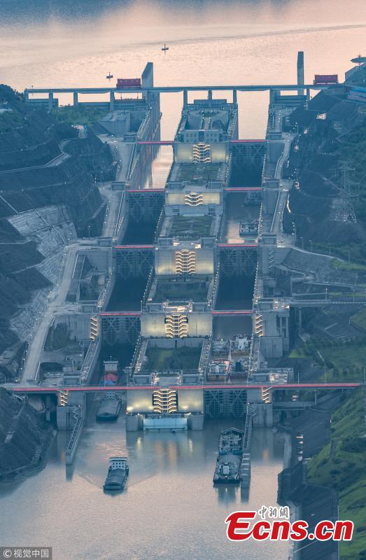 Ships pass the Three Gorges Dam’s five-stage ship lock in Yichang, Central China’s Hubei Province, Aug. 1, 2018. Authorities made use of a break in continuous rain to ease shipping pressure between the Three Gorges Dam and the Gezhouba Dam, both large-scale water control projects on the Yangtze River. Previously, hundreds of ships were suspended to be both upstream and downstream of the Three Gorges Dam due to the massive amounts of floodwater - 35,000 cubic meters per second - being discharged from the dam, which affects navigation safety. (Photo/VCG)