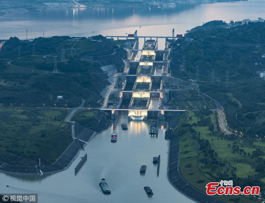 Ships pass the Three Gorges Dam’s five-stage ship lock in Yichang, Central China’s Hubei Province, Aug. 1, 2018. Authorities made use of a break in continuous rain to ease shipping pressure between the Three Gorges Dam and the Gezhouba Dam, both large-scale water control projects on the Yangtze River. Previously, hundreds of ships were suspended to be both upstream and downstream of the Three Gorges Dam due to the massive amounts of floodwater - 35,000 cubic meters per second - being discharged from the dam, which affects navigation safety. (Photo/VCG)
