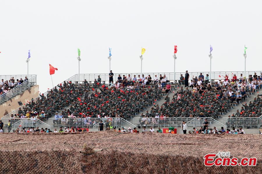 Public spectators and soldiers watch the \