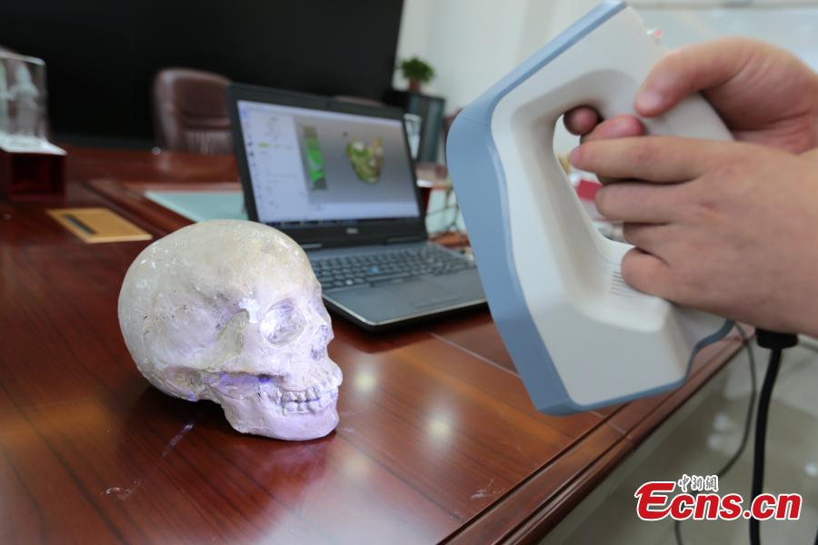 A student scans a skull for research in Northwest University in Xi’an City, Shaanxi Province, Aug. 2, 2018. Through \