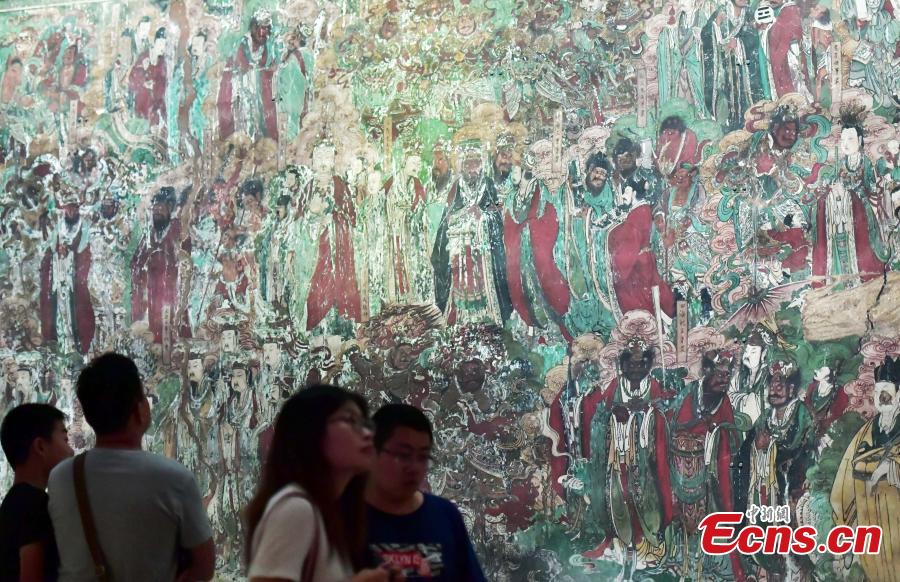 Visitors look at an exhibition of murals at the Hebei Museum in Shijiazhuang City, Hebei Province, Aug. 2, 2018. The murals date back to the Ming Dynasty (1368-1644) and were from the Pilu Temple. They are known for their great composition, superb craftsmanship and rich connotation. (Photo: China News Service/Zhai Yujia)