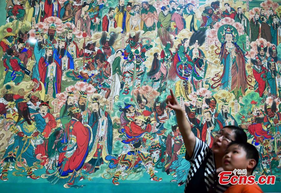 Visitors look at an exhibition of murals at the Hebei Museum in Shijiazhuang City, Hebei Province, Aug. 2, 2018. The murals date back to the Ming Dynasty (1368-1644) and were from the Pilu Temple. They are known for their great composition, superb craftsmanship and rich connotation. (Photo: China News Service/Zhai Yujia)