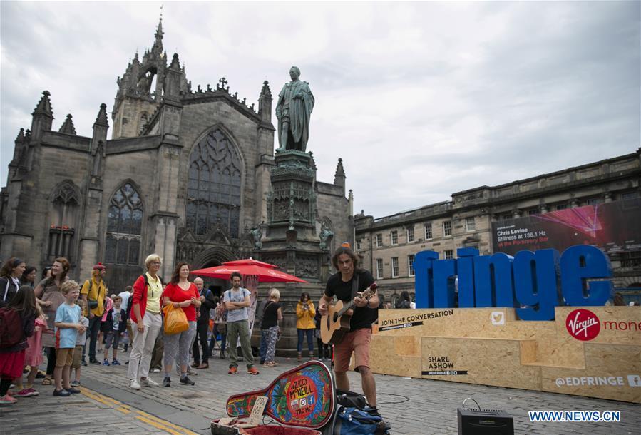 An Australian plays guitar on the opening day of the Edinburgh Festival Fringe 2018 in Edinburgh, Scotland, Britain on Aug. 3, 2018. (Xinhua/Han Yan)