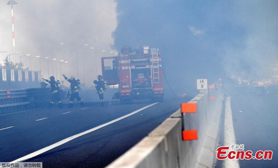 Firefighters work at the site of an explosion on a highway in the outskirts of Bologna, Italy, Aug. 6, 2018. The explosion killed at least two people and injured up to 70 as a section of the thoroughfare collapsed, police said. (Photo/Agencies)