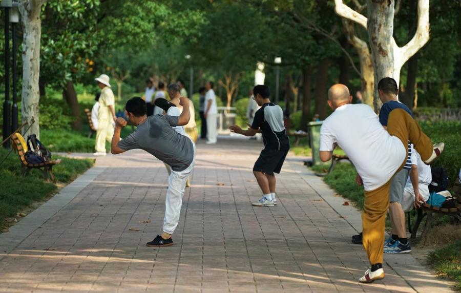 People practice Tai Chi in the park.