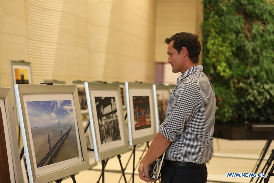A visitor views photos at the photo exhibition \