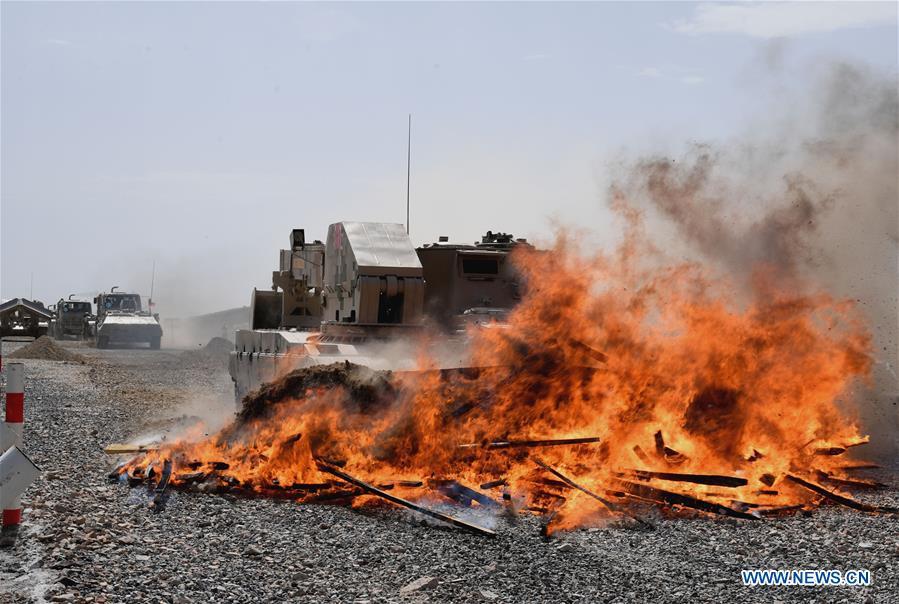 A vehicle operated by a Chinese crew cleans up the fire barrier during a match of the International Army Games 2018 in Korla, northwest China\'s Xinjiang Uygur Autonomous Region, Aug. 8, 2018. Three contests of the International Army Games 2018 in northwest China\'s Xinjiang Uygur Autonomous Region ended here Wednesday. (Xinhua/Zhang Yongjin)