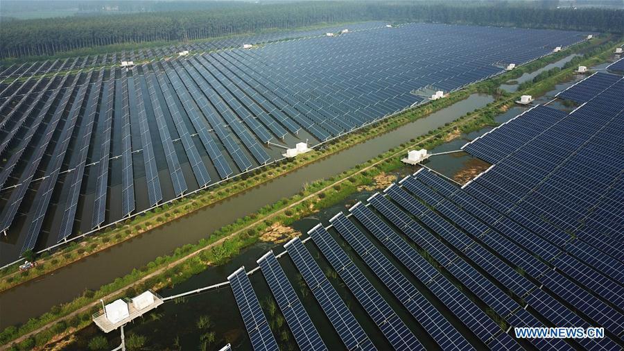 Aerial photo taken on Aug. 9, 2018 shows a photovoltaic power plant built above the fish pond in Yintu Township of Jinhu County, east China\'s Jiangsu Province. (Xinhua/Li Yuze)