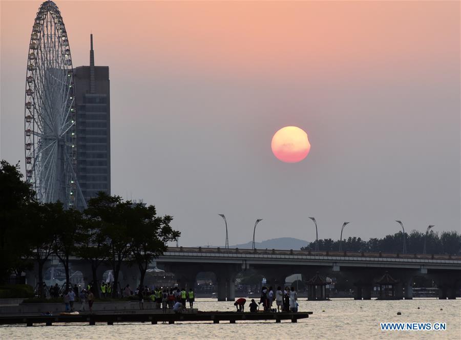 Photo taken on Aug. 11, 2018 shows the sun going through a partial solar eclipse in Wuxi City, east China\'s Jiangsu Province. (Xinhua/Huan Yueliang)