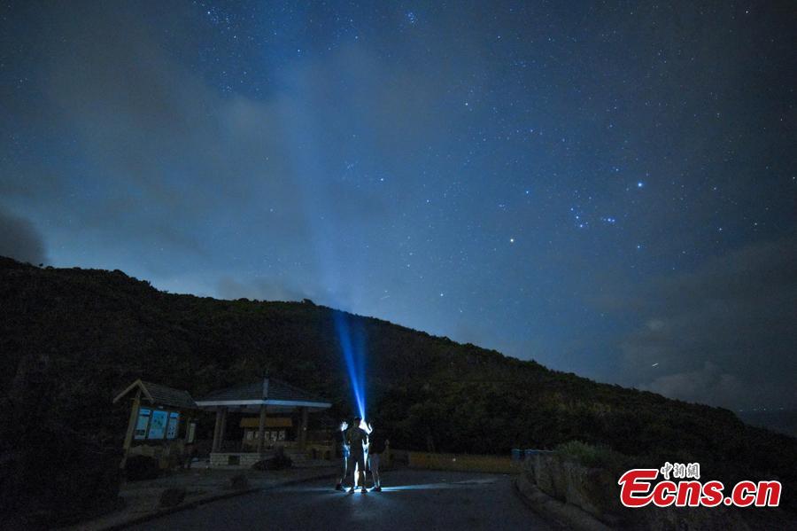 Visitors watch the Perseid meteor shower near the High Island Reservoir, where there’s little light pollution, in Hong Kong, August 13, 2018. (Photo: China News Service/ Sheung Man Mak)