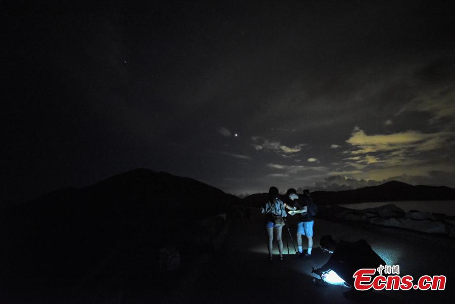 Visitors watch the Perseid meteor shower near the High Island Reservoir, where there’s little light pollution, in Hong Kong, August 13, 2018. (Photo: China News Service/ Sheung Man Mak)