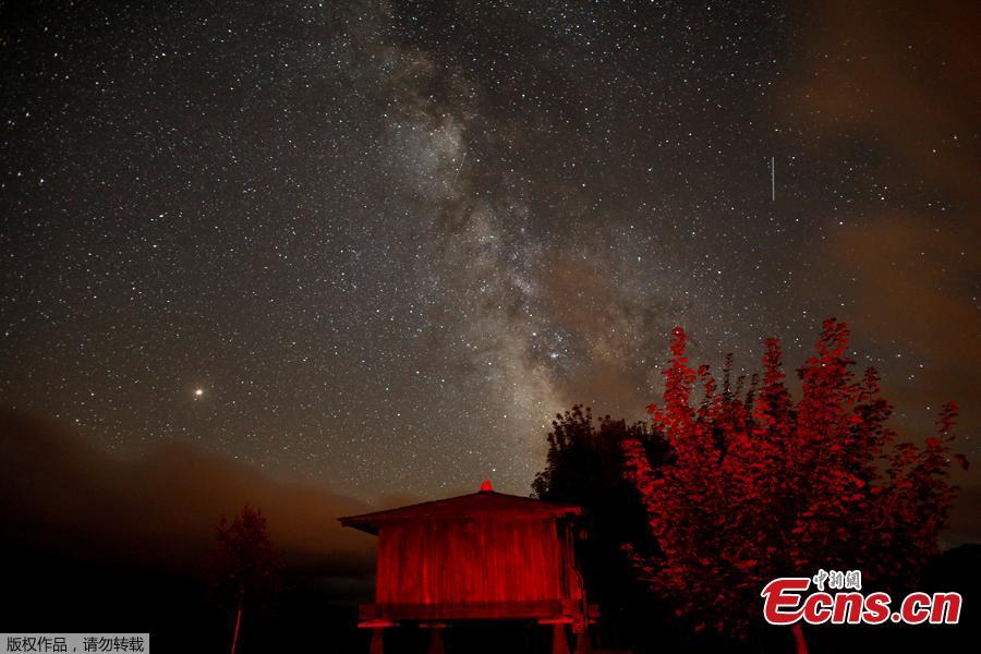 A meteor streaks past stars and the Milky Way in the night sky during the Perseids meteor shower in Berducedo, Spain, August 12, 2018. (Photo/Agencies)